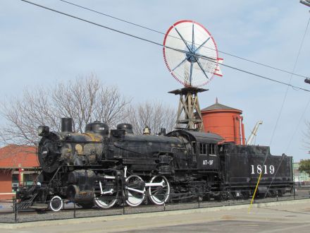 Old railroad engine with windmill and water tower in Lamar