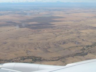 First glimpses of the dry prairie near Denver and the Rocky Mountains in the background